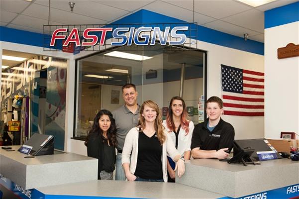 Joelene Calvert with her FASTSIGNS team